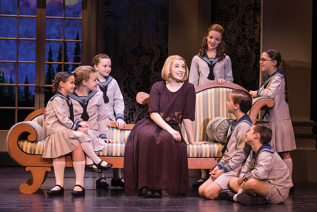 Jill-Christine Wiley as Maria and the von Trapp children. Photo by Matthew Murphy